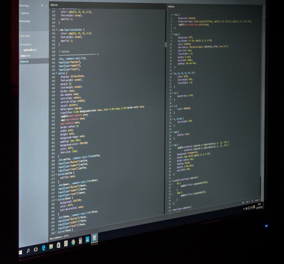 A dual screen setup showcasing programming code and image editing software.
